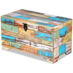 an old trunk is painted with multicolored paint and metal hardware on the bottom