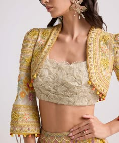 Elevate your ensemble with this ivory chanderi bolero jacket, adorned with intricate contrast cordwork and delicate beadwork. This piece exudes sophistication and style, adding a touch of elegance to any outfit. Embroidered Blouse Piece With Cape Sleeves For Wedding, Floral Embroidered Choli With Cape Sleeves For Parties, Party Choli With Cape Sleeves And Floral Embroidery, Party Choli With Floral Embroidery And Cape Sleeves, Fitted Choli With Resham Embroidery And Cape Sleeves, Fitted Silk Nehru Jacket For Reception, Silk Fitted Nehru Jacket For Reception, Elegant Front Open Choli For Wedding, Fitted Silk Nehru Jacket With Chikankari Embroidery