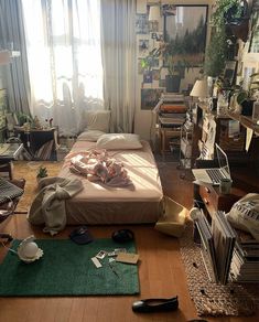 a messy bedroom with lots of clutter on the floor