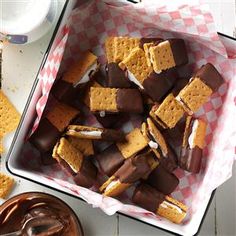 chocolate and marshmallows in a baking dish next to a bowl of dip