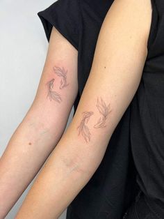 two people with matching tattoos on their arms