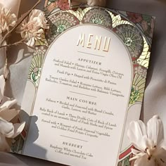 a menu with flowers on top of it