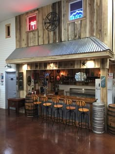 the inside of a bar with several stools