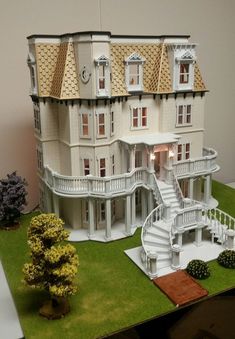 a large doll house with stairs and balconies on the top floor is shown