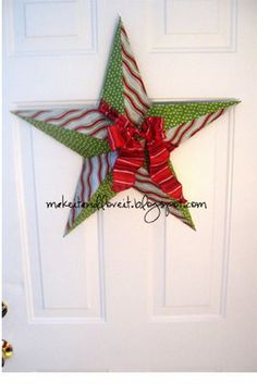 a green and red christmas star hanging on a white door