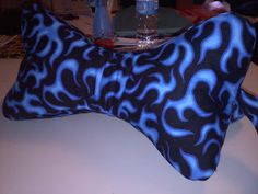 a blue and black patterned pillow sitting on top of a table