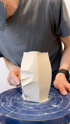 a man is working on a sculpture in the process of making it out of paper