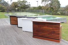 an outdoor bar on a deck near a tennis court