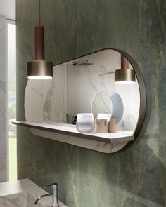 a bathroom sink with a mirror above it and lights hanging from the ceiling over it