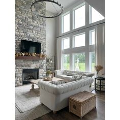 a living room filled with furniture and a flat screen tv mounted on the wall above a fireplace