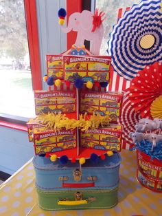 an elephant themed birthday party with circus decorations and candy boxes on a table in front of a window