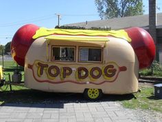 an inflatable hot dog trailer is on display