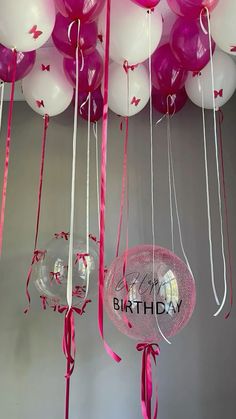 balloons and streamers are hanging from the ceiling for a birthday party or special occasion