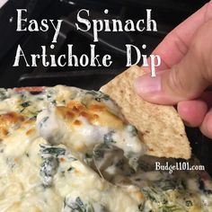 spinach artichoke dip is being held up with a tortilla chip