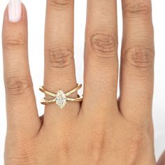 a woman's hand with a ring on it and a diamond in the middle