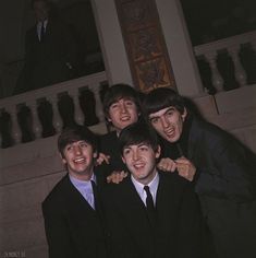 the beatles posing for a photo in front of some stairs