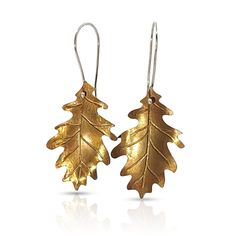 Take a bit of fall with you in these handcrafted brass and argentium silver oak leaf earrings. Oak Leaves are a symbol of wisdom, strength and endurance. Leaves are a symbol of growth and renewal. Spring leaves symbolize innocence and new beginnings while leaves in the fall represent shedding old ways and peace. Each piece is one-of-a-kind and handcrafted with raw materials using traditional artisan jewelry techniques. NuGold (brass), Argentium Silver 1.5 x .5in Symbol Of Growth, Oak Leaf Earrings, Spring Leaves, Old Ways, Silver Oak, Bat Earrings, Moon Studs, Oak Leaves, Golden Oak