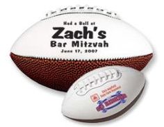 a white and brown football with the name zach's bar mitzvah on it