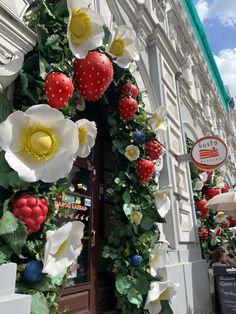 a building decorated with flowers and strawberries