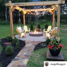 an outdoor fire pit surrounded by chairs and lights