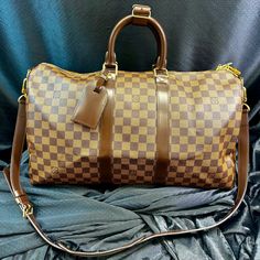 Elevate Your Travel Game With This Impeccable Louis Vuitton Keepall Bandouliere 45 In The Coveted Damier Ebene Pattern. Crafted With Precision And Finesse, This Iconic Piece Is Priced At $2,240, Obo. Immaculately Maintained In Excellent Condition, It Is A Testament To Timeless Elegance. Whether Jet-Setting Or City-Hopping, Its Spacious Interior Effortlessly Accommodates Your Essentials. Complete With Its Original Dust Cover, This Exquisite Bag Is An Investment In Both Style And Quality. Secure Your Statement Piece Now And Redefine Travel In Unparalleled Louis Vuitton Style. Louis Vuitton Keepall, Travel Games, Damier Ebene, Dust Cover, Jet Set, Travel Luggage, Womens Tote Bags, Luggage Bags, Travel Bags