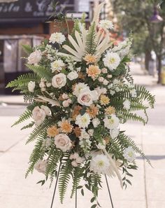 a bunch of flowers that are sitting on a stand