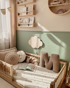 a baby's room with a wooden crib and stuffed animals on the bed