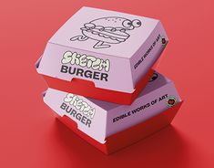 two burger boxes sitting side by side on a red surface, one with the lid open