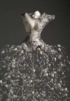 a sculpture made out of wire and pearls