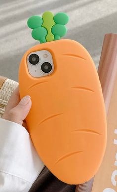 a person holding an iphone case with a carrot on it