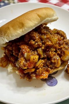 a sloppy joe sandwich on a white plate