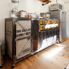 an industrial kitchen with stainless steel appliances and wood flooring is pictured in this image