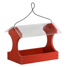 a red bird feeder hanging from a string