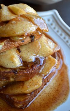 a stack of pancakes covered in syrup on a plate