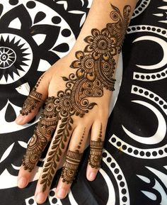 a henna tattoo on the hand of a woman