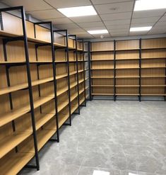 empty bookshelves in the middle of a large room