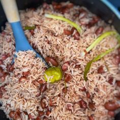 rice and beans are being cooked in a skillet