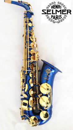 a blue and gold saxophone sitting on top of a white table