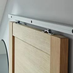 a close up of a wooden cabinet under a mirror