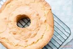 a frosted donut sitting on top of a cooling rack