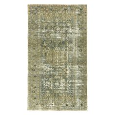 an antique rug with green and beige colors on the bottom, in front of a white background