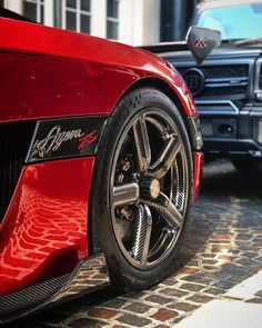 two red sports cars parked next to each other