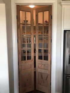 a wooden door with glass panels in a kitchen