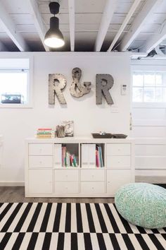 a room with black and white striped rugs on the floor