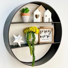 a shelf with some plants and decorations on it