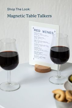 two glasses of red wine are sitting on a table