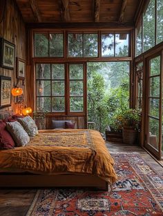 a bed sitting in a bedroom next to a window filled with lots of windows and plants