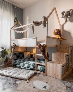 a child's bedroom with bunk beds and stuffed animals