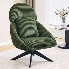 a green chair sitting on top of a white rug