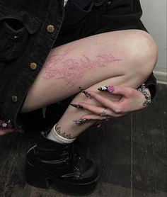 a woman with tattoos on her leg and legs